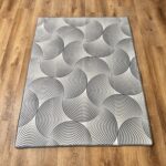 A soft, light gray foam rug with a modern pattern