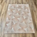 A soft, light beige foam rug with a modern pattern