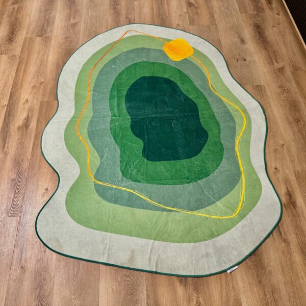A soft green rug in an unusual shape