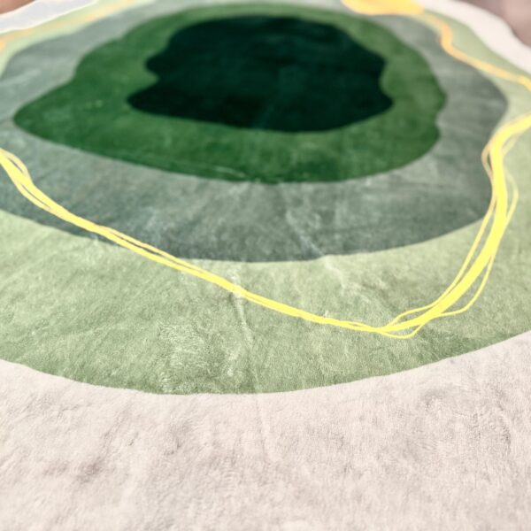 A soft green rug in an unusual shape