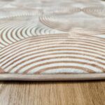 A soft, light beige foam rug with a modern pattern