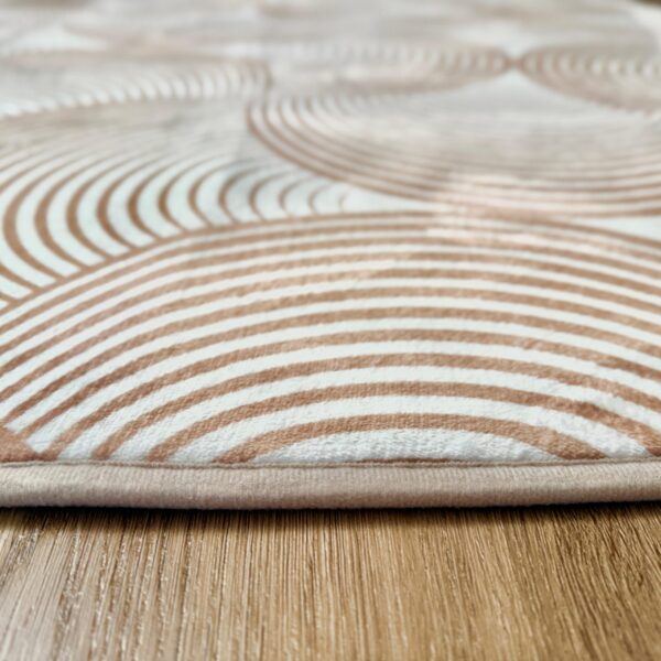 A soft, light beige foam rug with a modern pattern