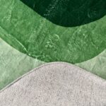 A soft green rug in an unusual shape