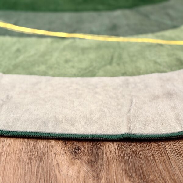 A soft green rug in an unusual shape