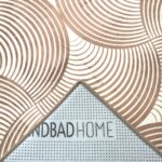 A soft, light beige foam rug with a modern pattern